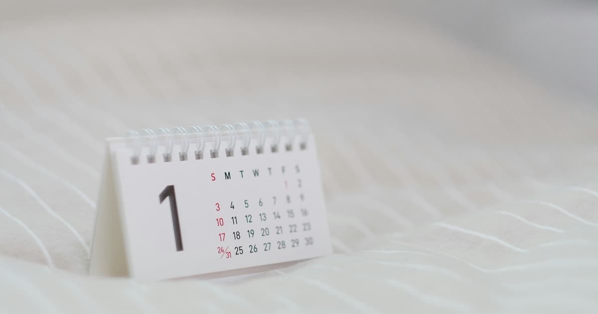 Tischkalender mit Monatsübersicht auf einem hellen Untergrund